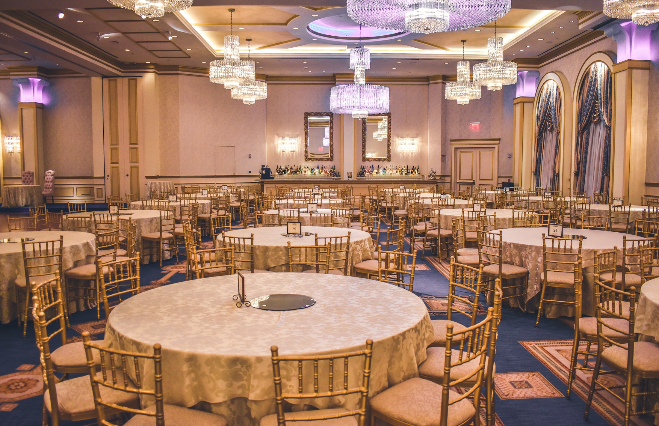 Champagne-toned ballroom with chandeliers